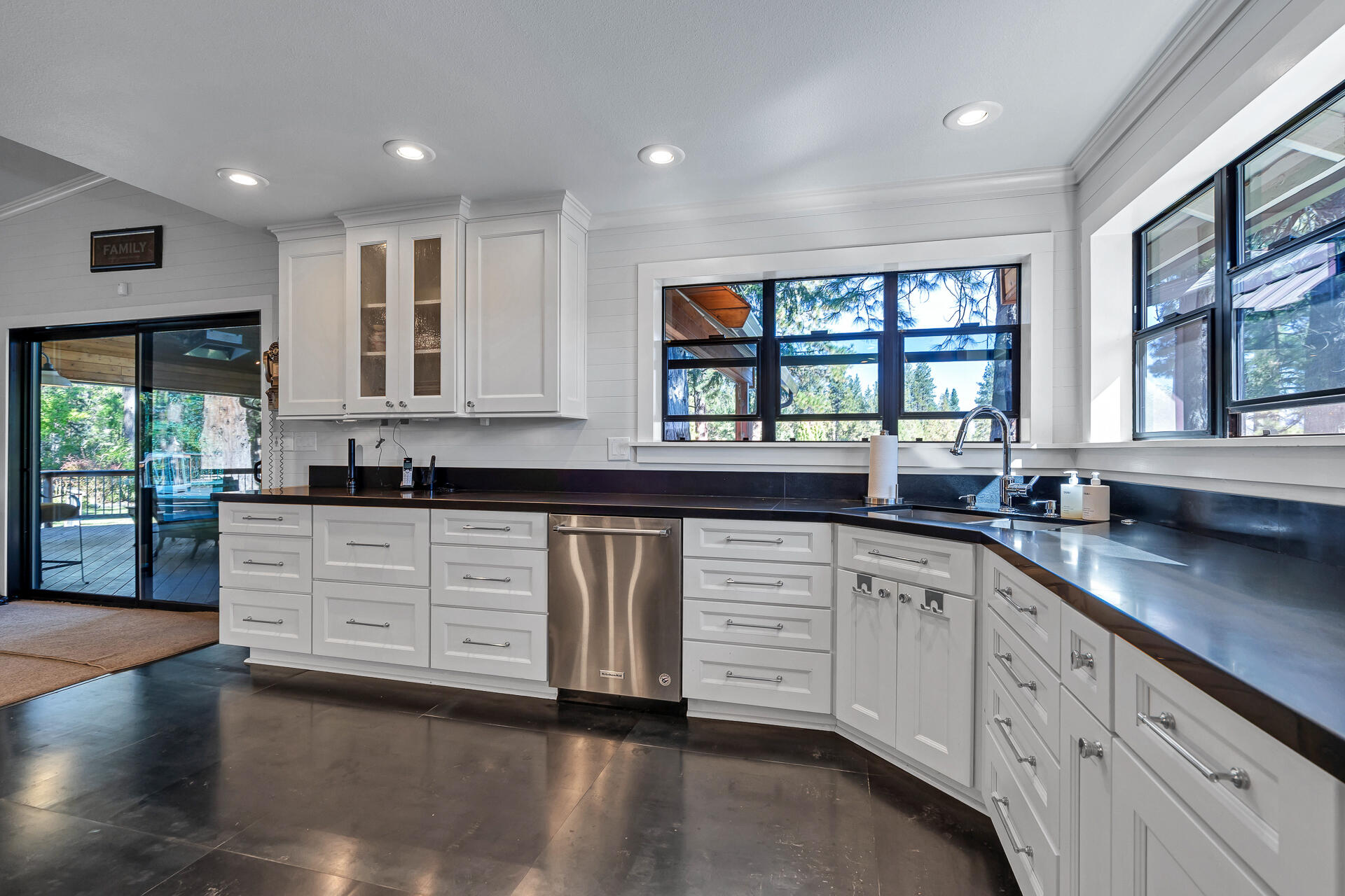 42048 Wilcox Road Hat Creek, CA 96040 - Photo 24 of 134 a kitchen with stainless steel appliances granite countertop a stove a sink and white cabinets with wooden floor
