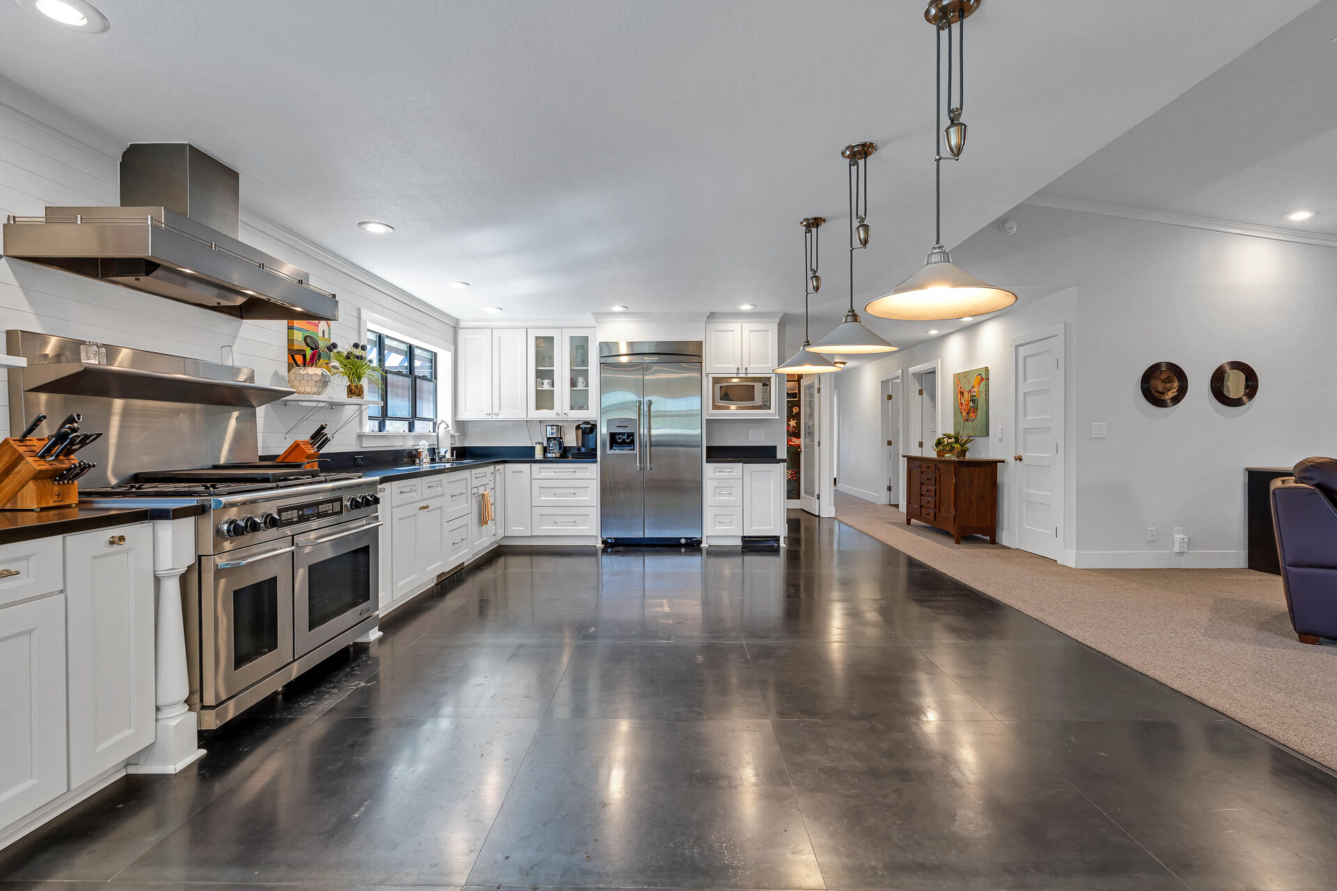 42048 Wilcox Road Hat Creek, CA 96040 - Photo 31 of 134 a kitchen with stainless steel appliances granite countertop a stove a sink a refrigerator and a wooden floor
