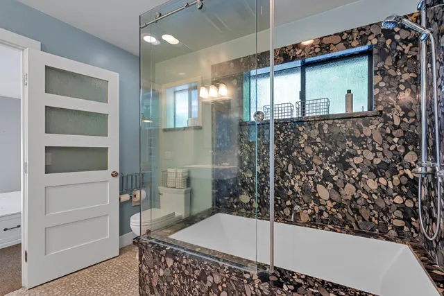 a bathroom with double sink and two mirror