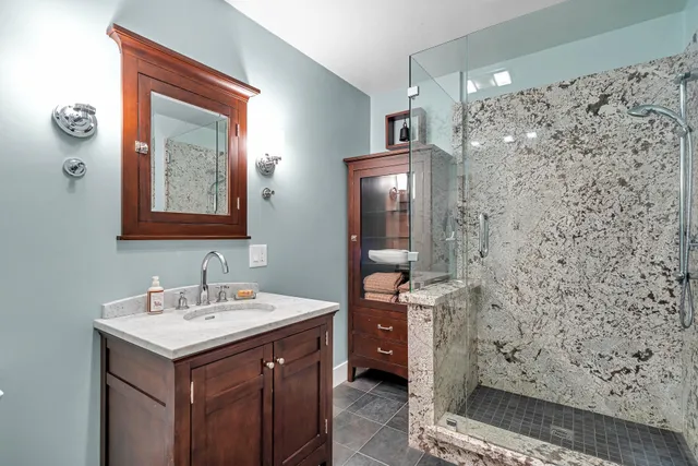 a swimming pool with an outdoor space and seating area