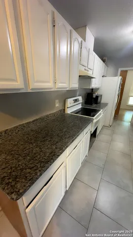 a kitchen with stainless steel appliances a stove a sink and a microwave