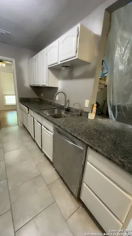 a kitchen with a sink and cabinets