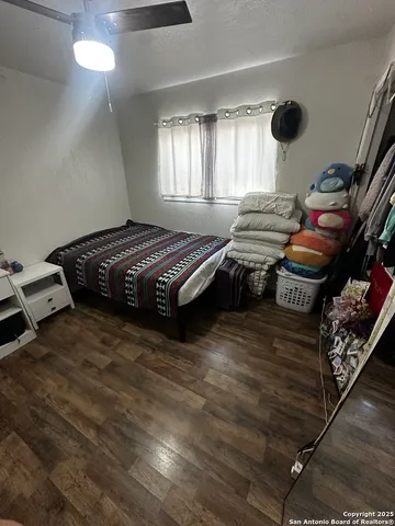 a spacious bedroom with a bed and window