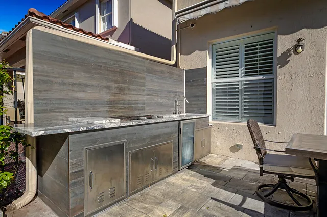 a balcony with table and chairs