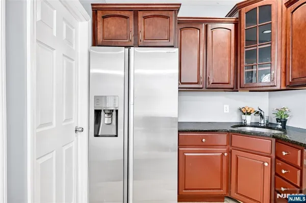 a kitchen with wooden cabinets and a stove top oven