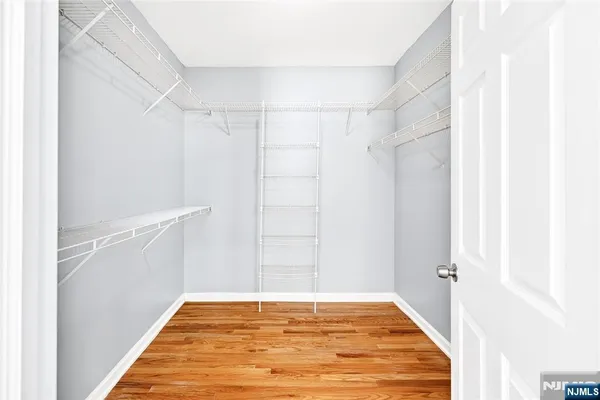 a view of a room with wooden floor and windows