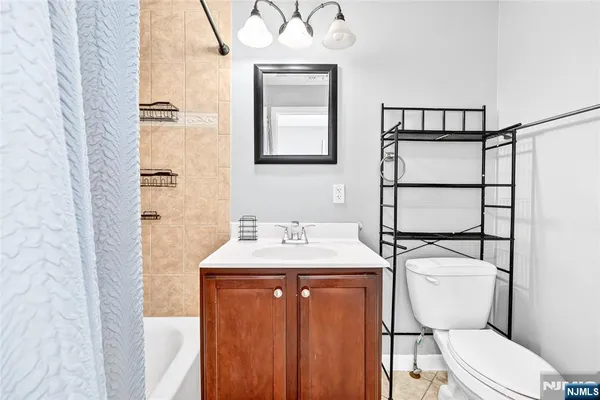 a view of a bedroom with wooden floor and a window