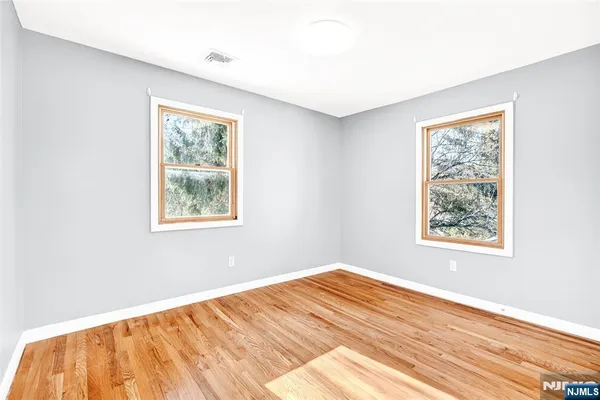 a view of a room with wooden floor and windows