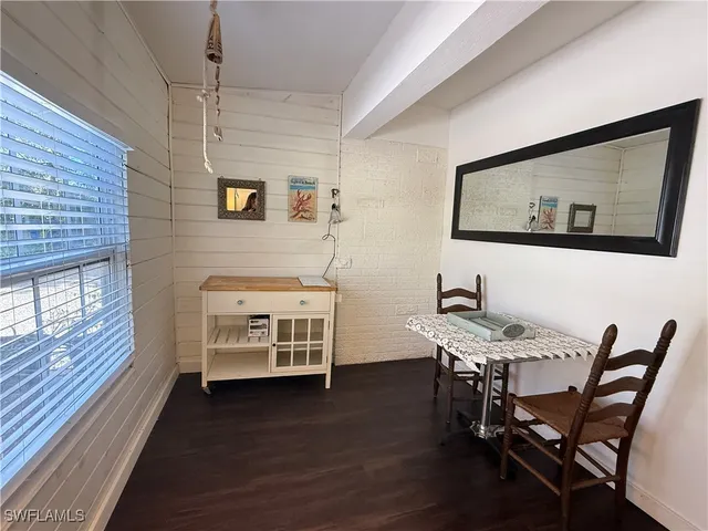 a view of a workspace with furniture and window