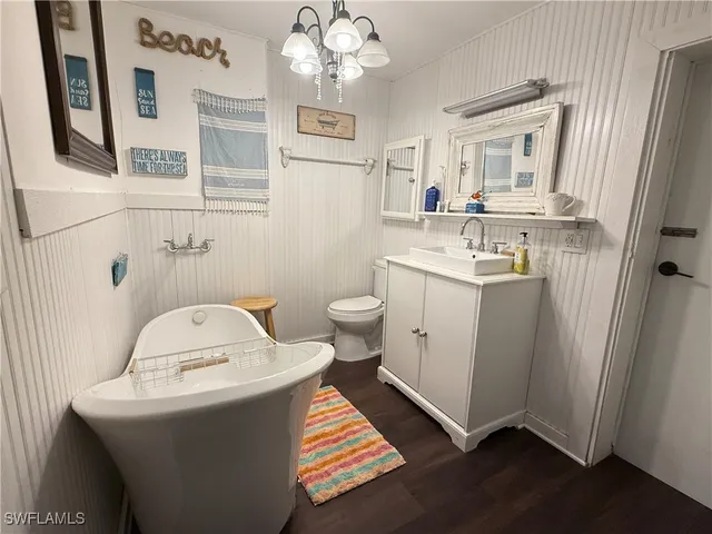 a bathroom with a sink toilet and mirror