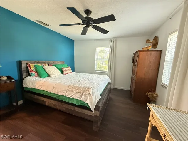 a bedroom with a bed and a large mirror