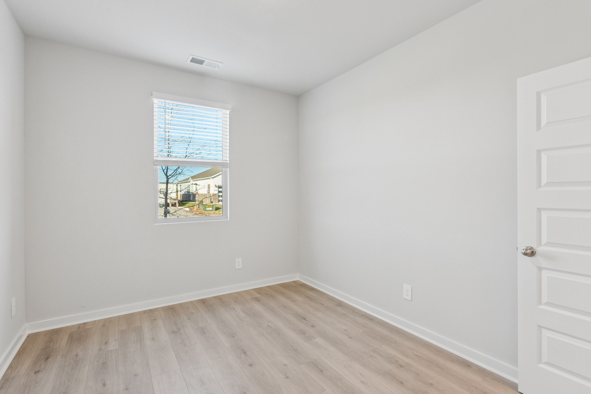 2069 Holmesburg Private Circle Gallatin, TN 37066 - Photo 13 of 16 a view of an empty room with a window and wooden floor