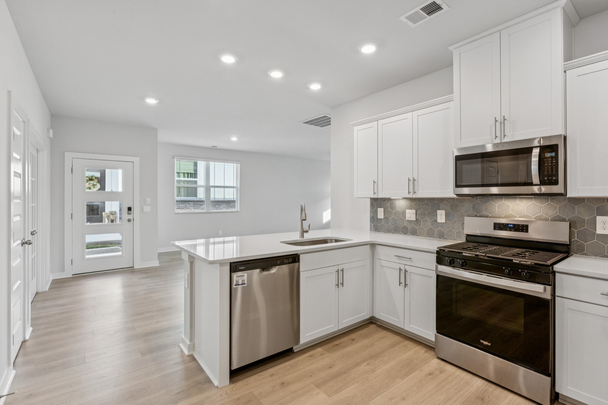 2069 Holmesburg Private Circle Gallatin, TN 37066 - Photo 3 of 16 a kitchen with stainless steel appliances kitchen island granite countertop a stove and a sink