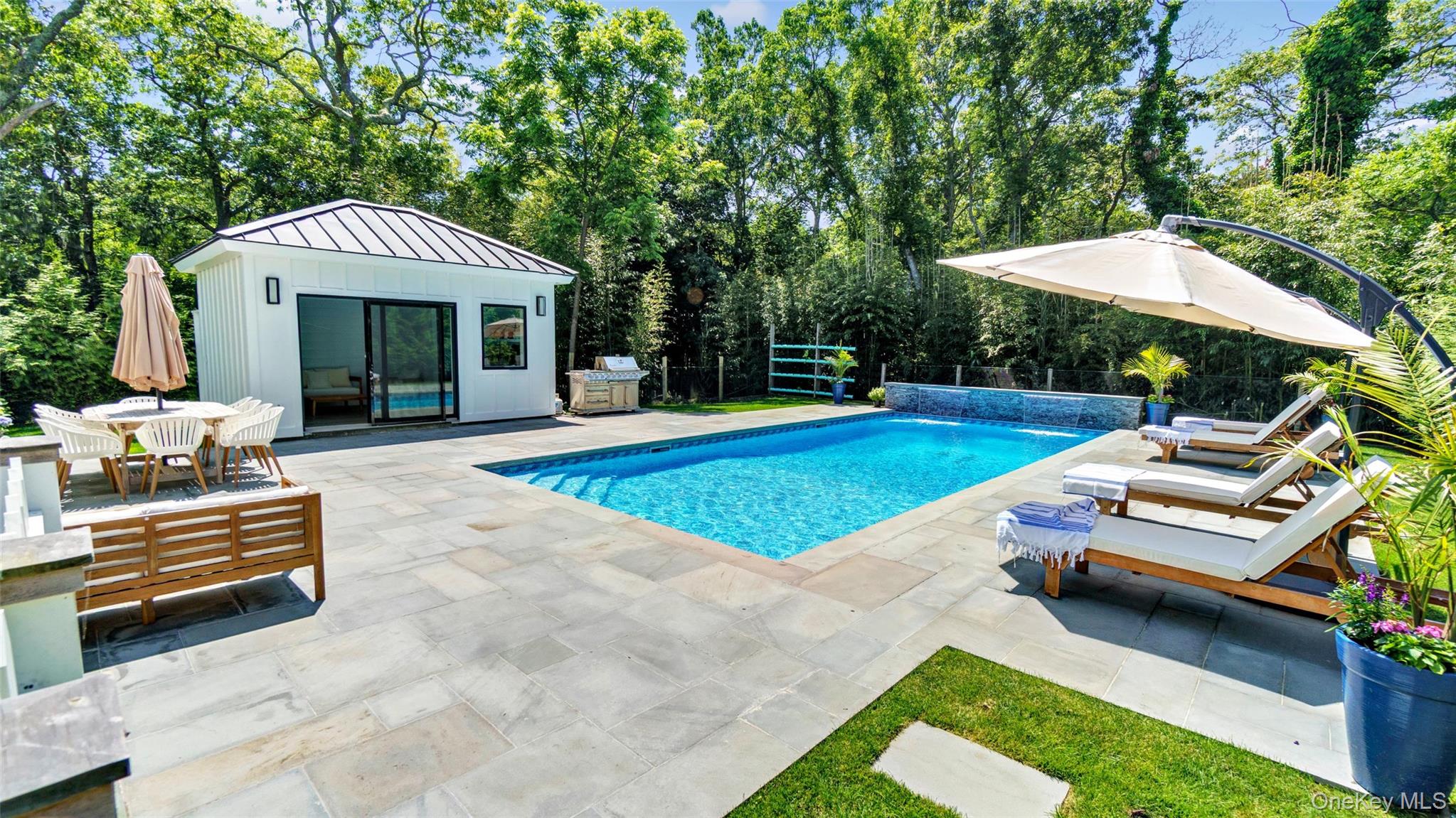 37 Wakeman Road Hampton Bays, NY 11946 - Photo 1 of 23 a front view of a house with garden