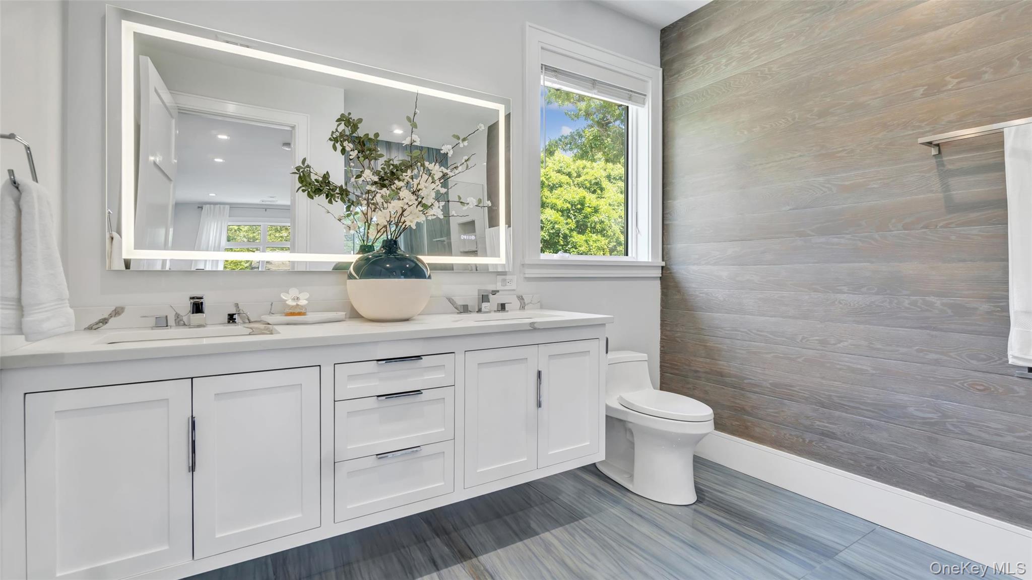37 Wakeman Road Hampton Bays, NY 11946 - Photo 12 of 23 a bathroom with a sink and a mirror