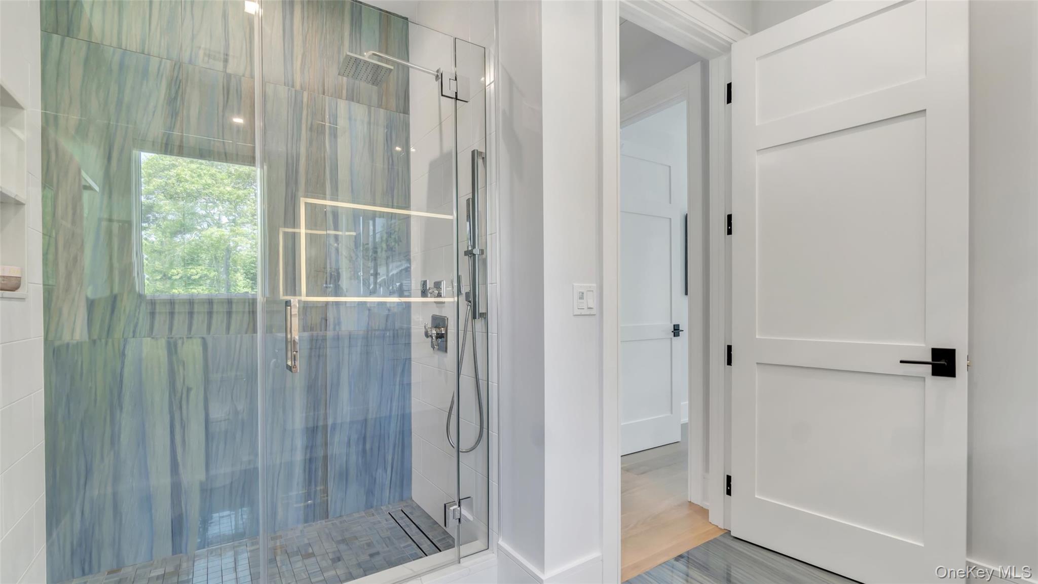 37 Wakeman Road Hampton Bays, NY 11946 - Photo 13 of 23 a bathroom with a glass shower door