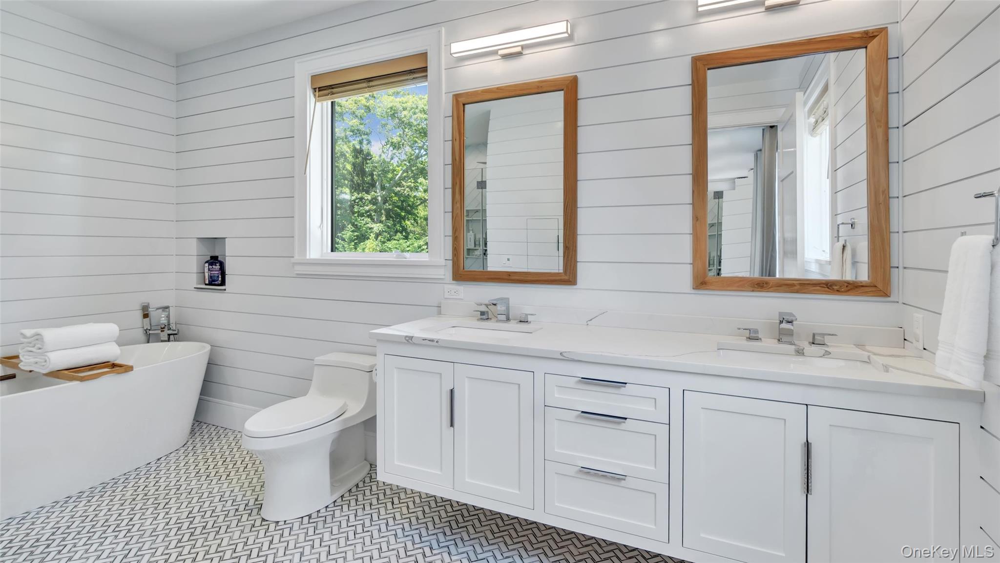 37 Wakeman Road Hampton Bays, NY 11946 - Photo 14 of 23 a bathroom with a sink a toilet and a bathtub