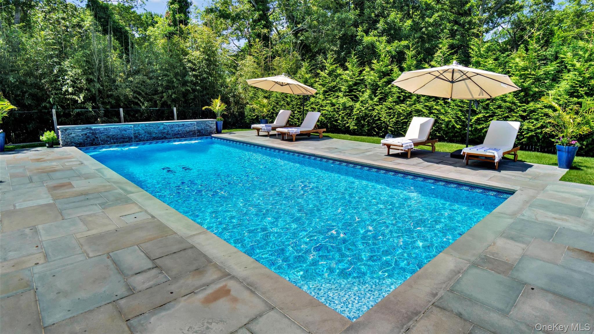 37 Wakeman Road Hampton Bays, NY 11946 - Photo 19 of 23 a view of a swimming pool with a patio