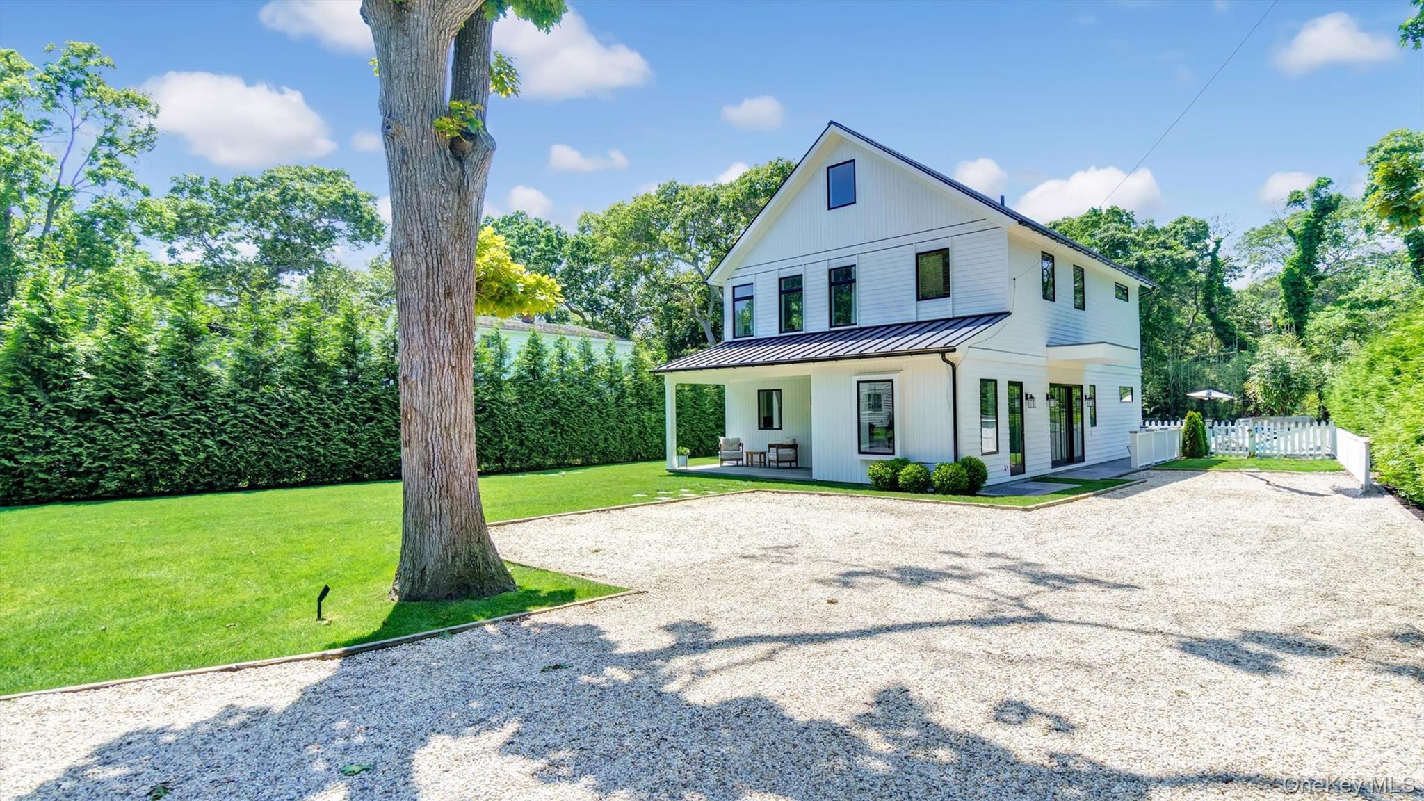 37 Wakeman Road Hampton Bays, NY 11946 - Photo 2 of 23 a front view of a house with garden