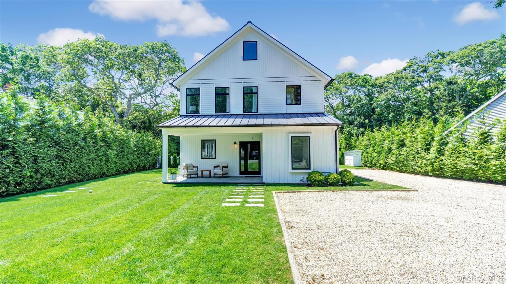 37 Wakeman Road Hampton Bays, NY 11946 - Photo 23 of 23 a front view of a house with a yard and porch