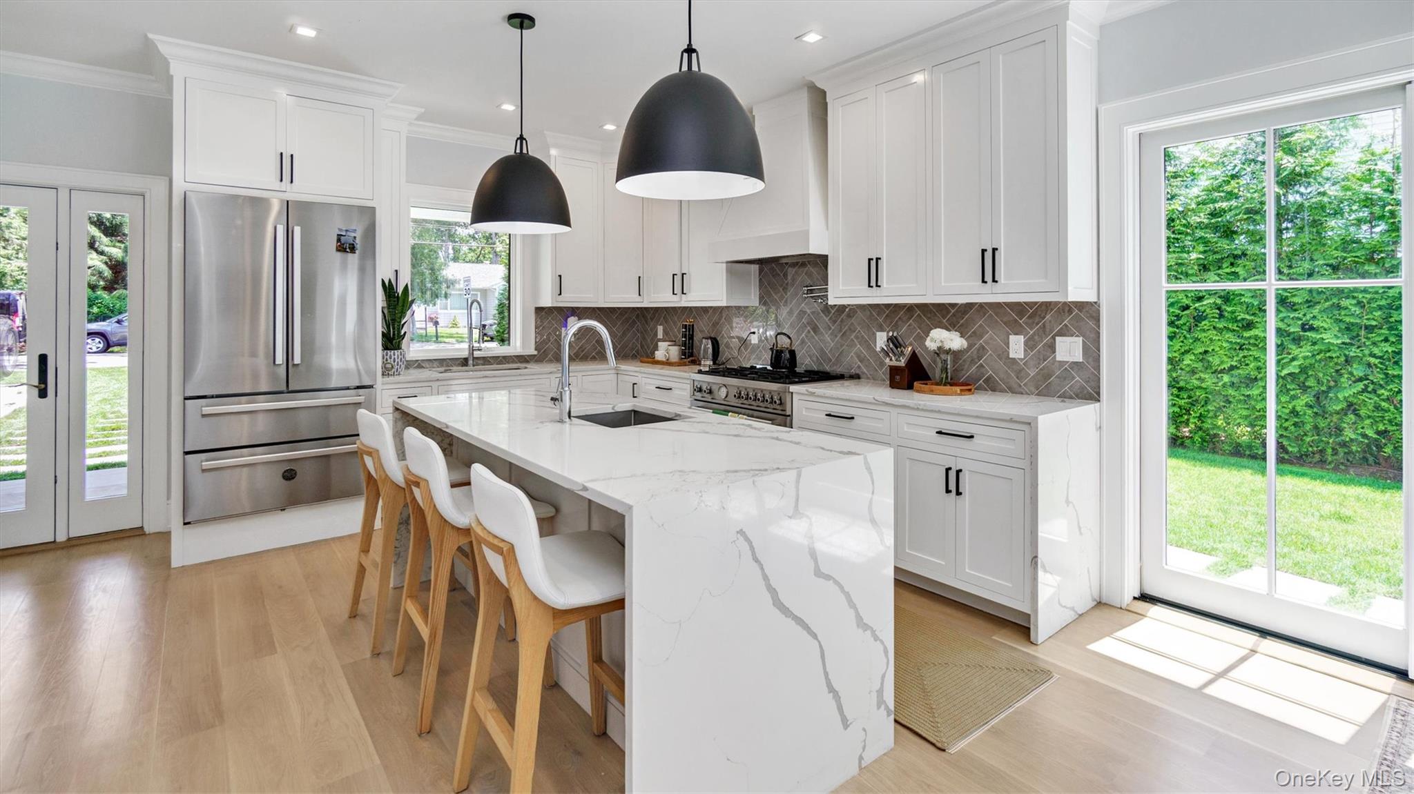 37 Wakeman Road Hampton Bays, NY 11946 - Photo 4 of 23 a kitchen with stainless steel appliances kitchen island a stove a sink a refrigerator and a wooden cabinets