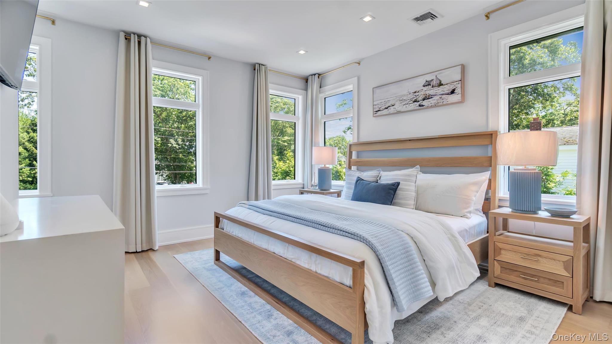 37 Wakeman Road Hampton Bays, NY 11946 - Photo 9 of 23 a bedroom with a bed and a large window