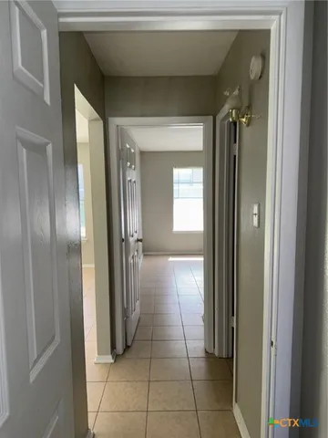 a view of a room that has a window and a rug