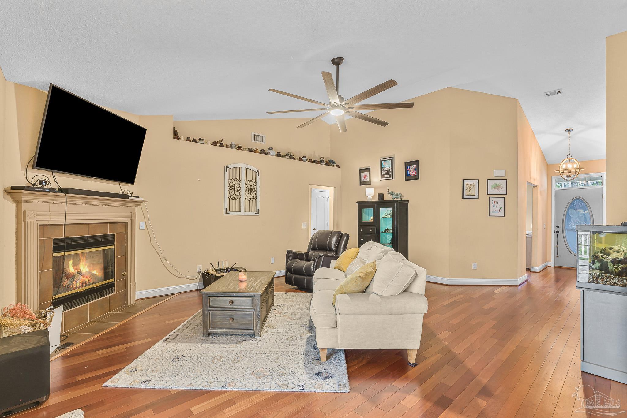 1089 Yellowstone Pass Cantonment, FL 32533 - Photo 11 of 45 a living room with furniture a fireplace and a flat screen tv