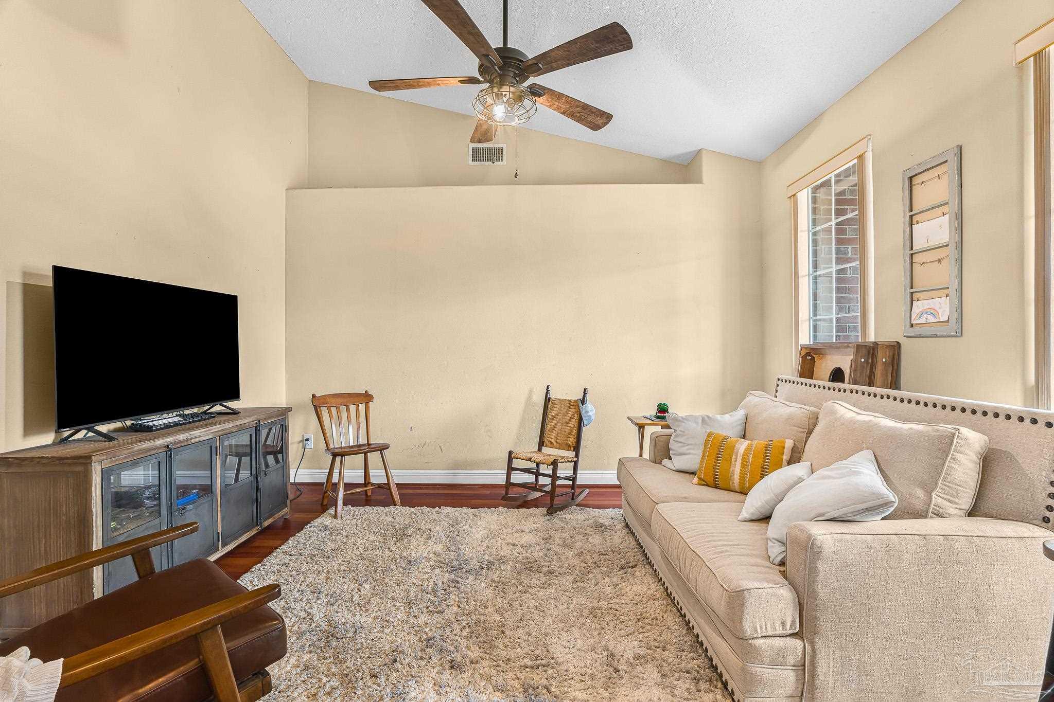 1089 Yellowstone Pass Cantonment, FL 32533 - Photo 16 of 45 a living room with furniture and a flat screen tv