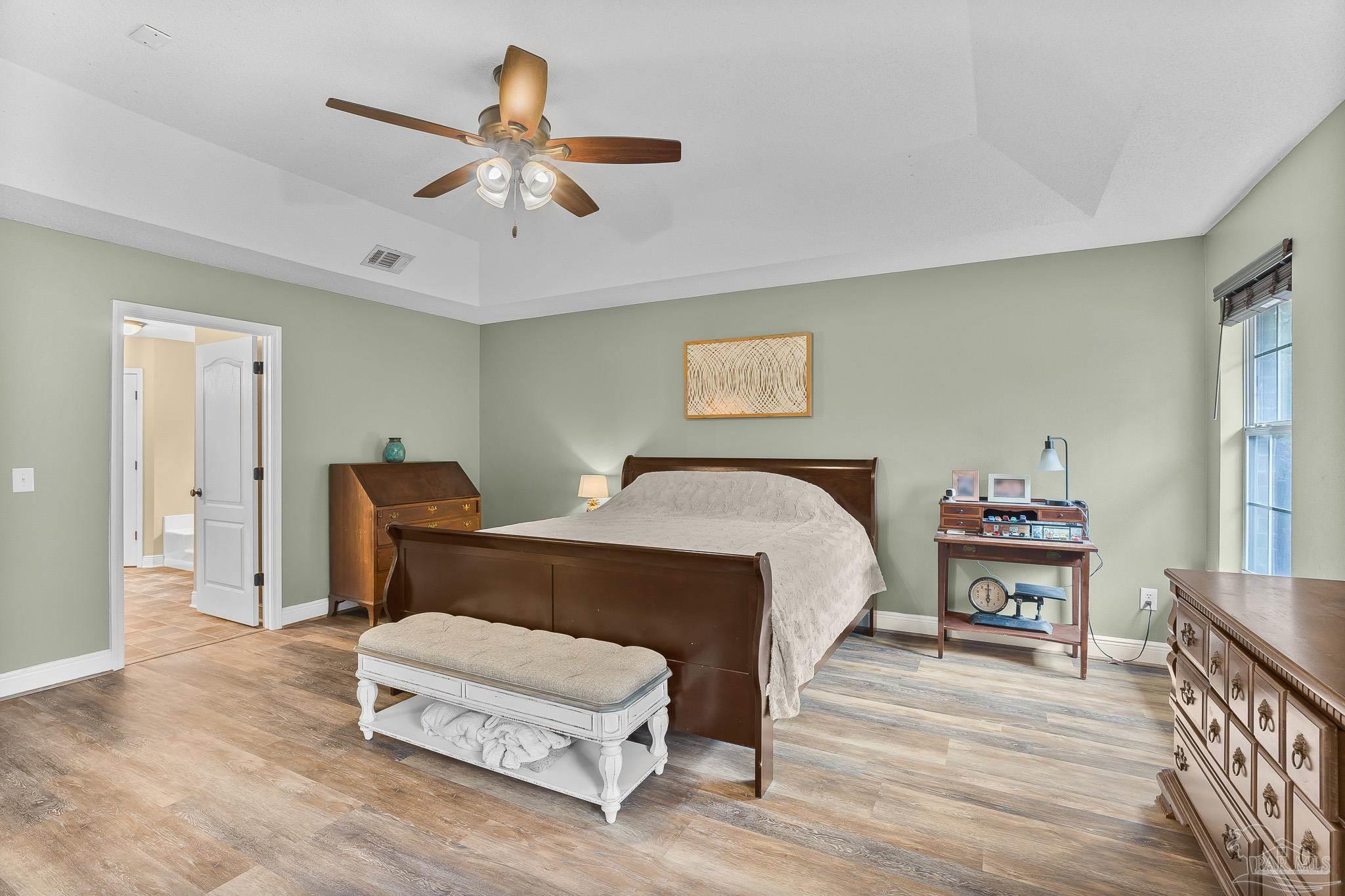 1089 Yellowstone Pass Cantonment, FL 32533 - Photo 17 of 45 a bedroom with a bed and a chandelier