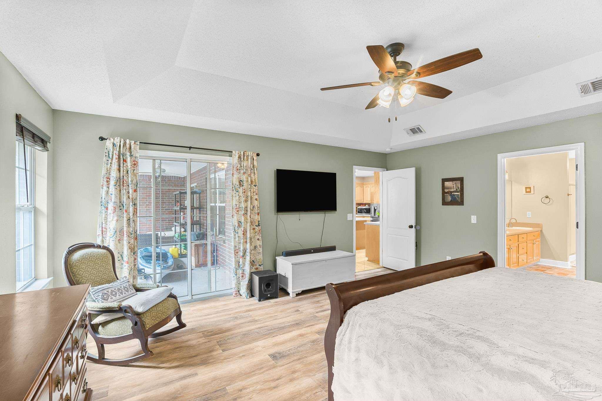 1089 Yellowstone Pass Cantonment, FL 32533 - Photo 18 of 45 a bedroom with a bed and large windows