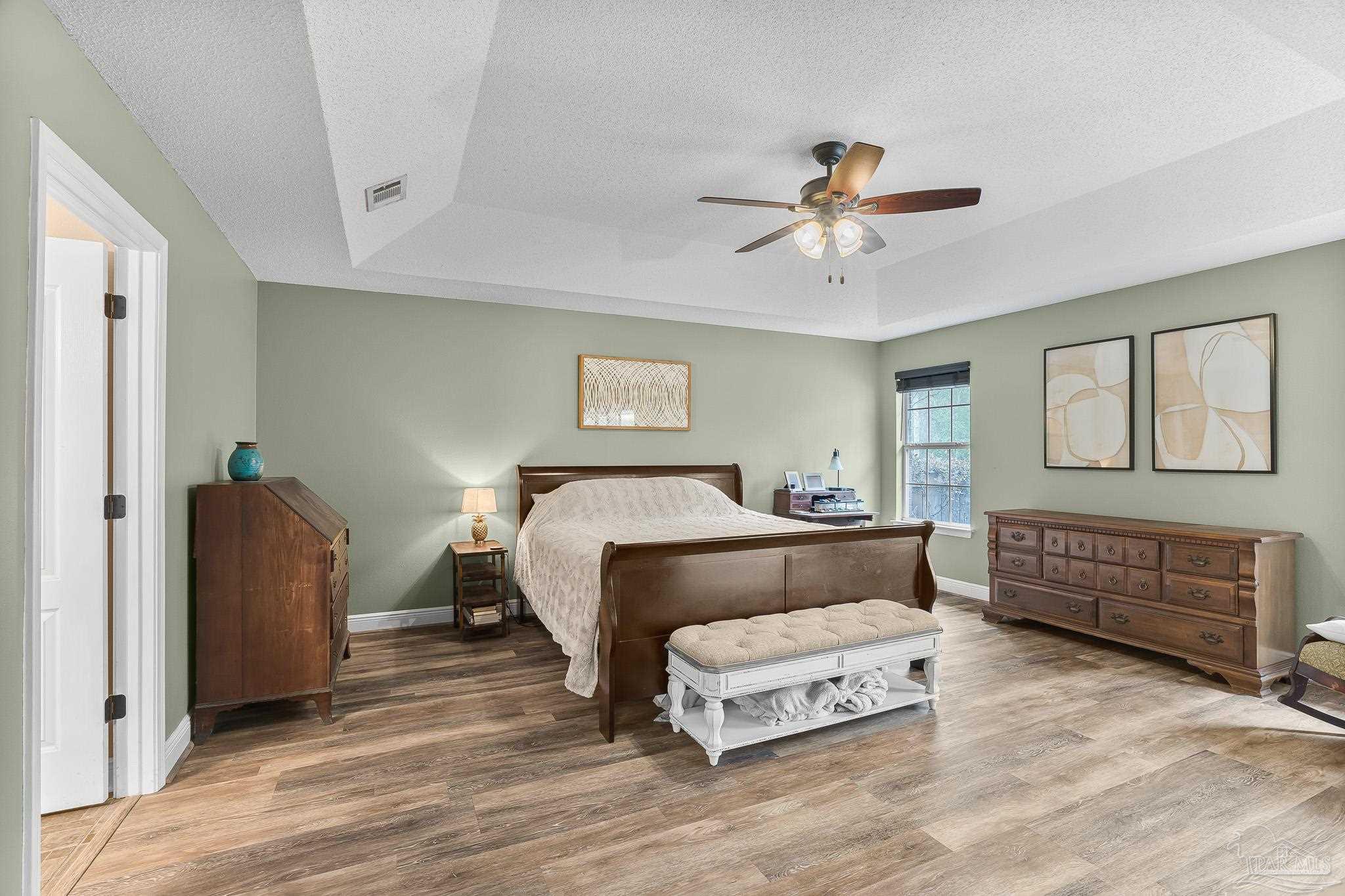 1089 Yellowstone Pass Cantonment, FL 32533 - Photo 19 of 45 a bedroom with a bed and wooden floor