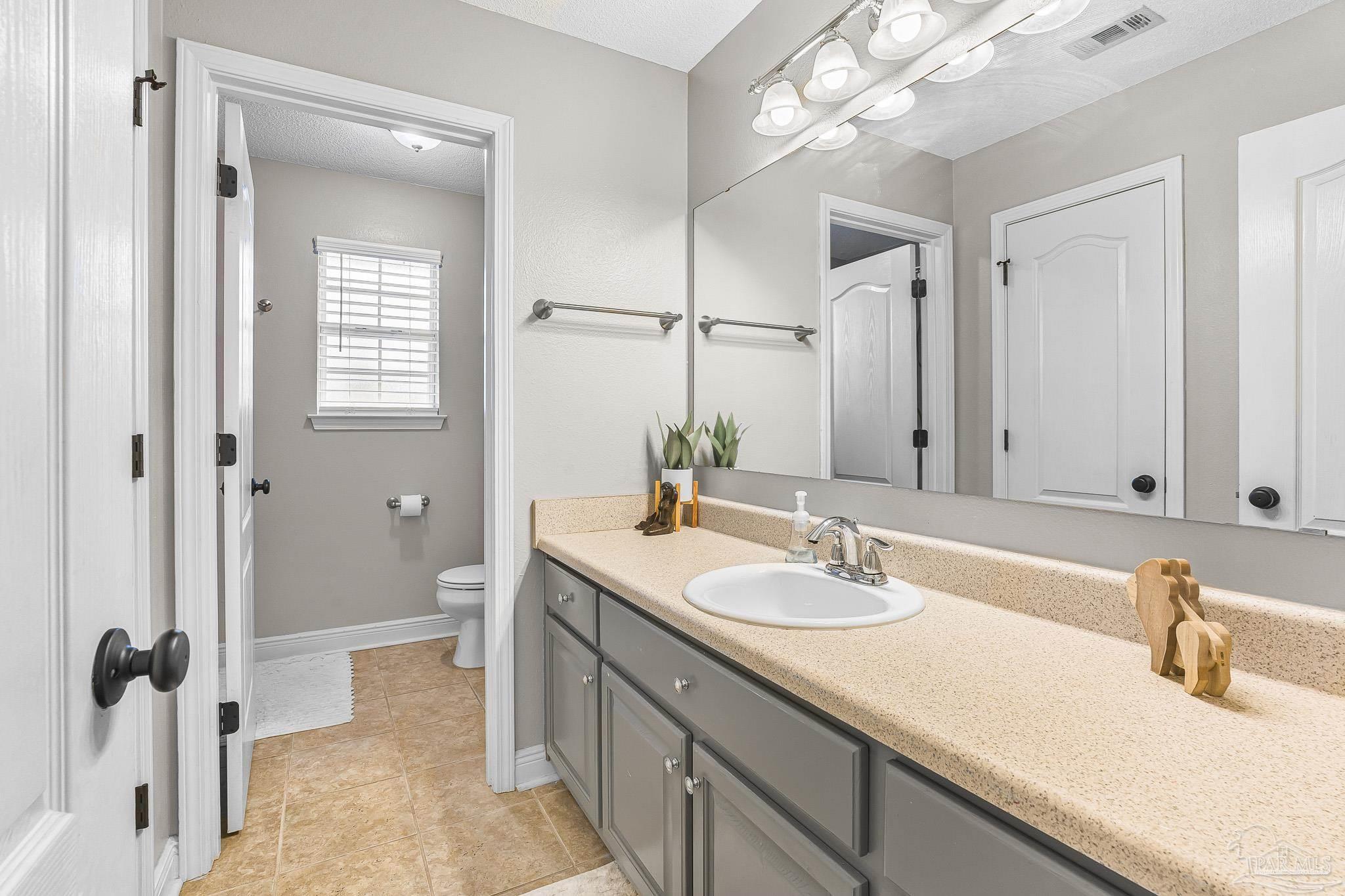 1089 Yellowstone Pass Cantonment, FL 32533 - Photo 20 of 45 a bathroom with a sink and a mirror