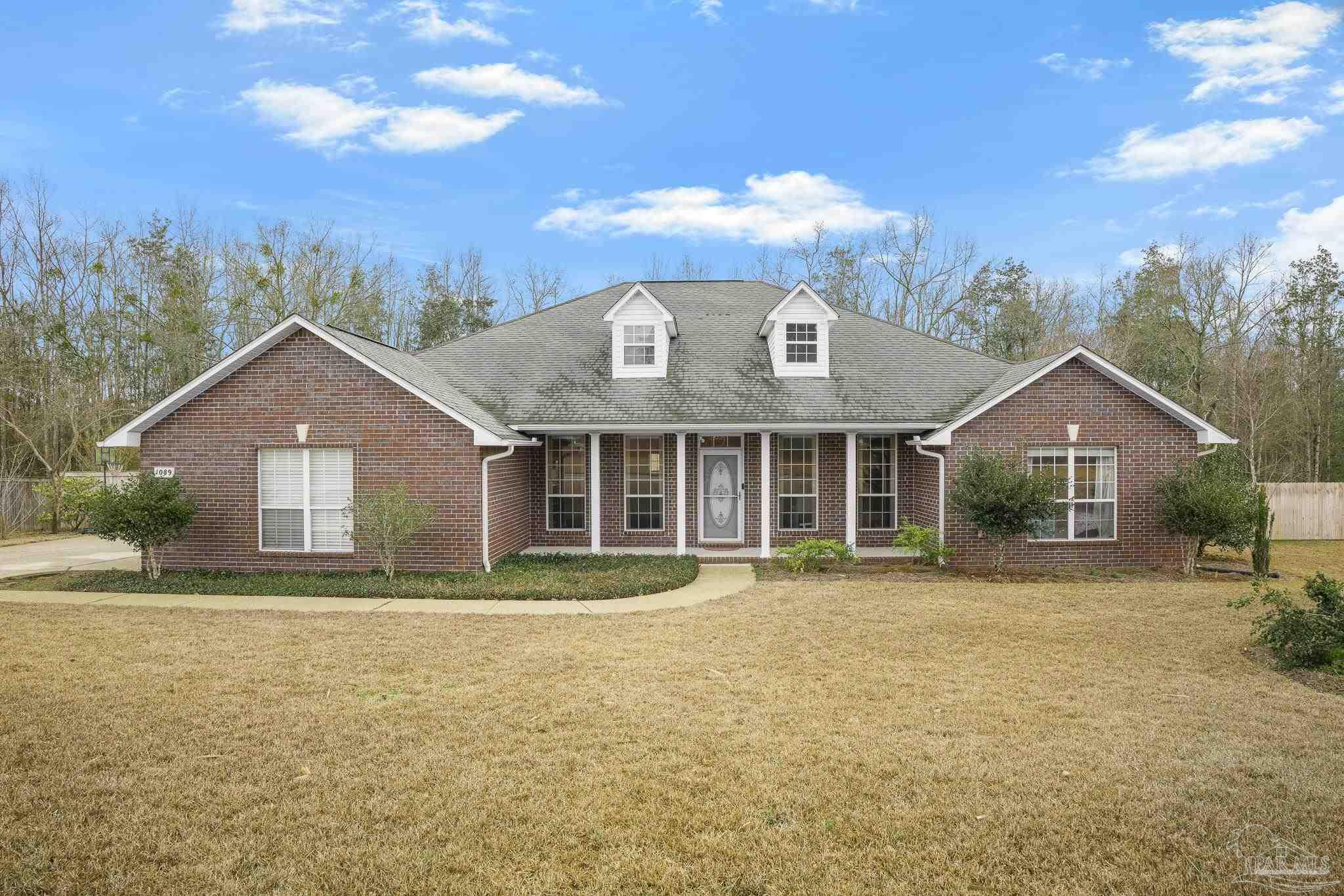 1089 Yellowstone Pass Cantonment, FL 32533 - Photo 2 of 45 a front view of a house with a yard