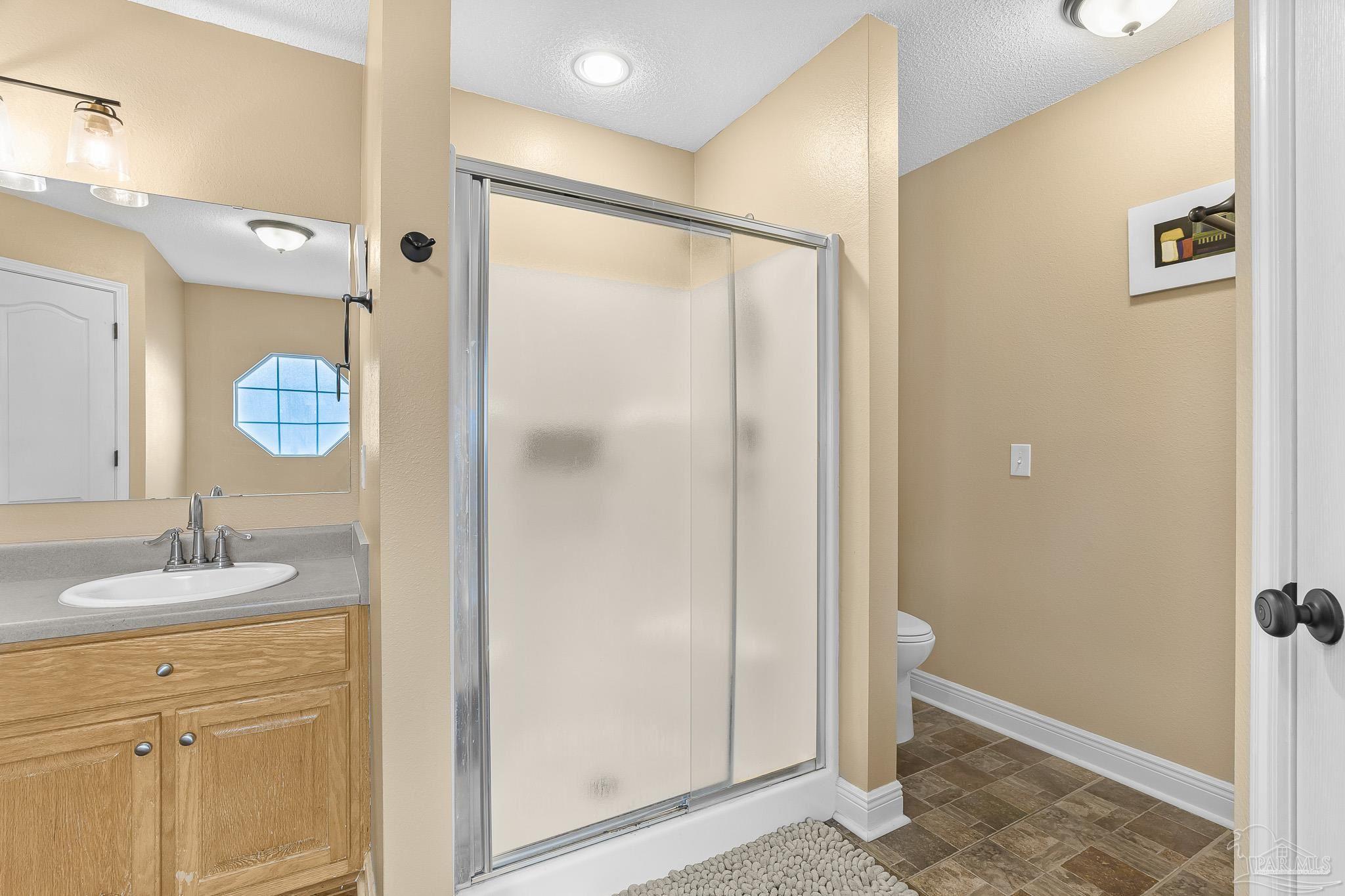1089 Yellowstone Pass Cantonment, FL 32533 - Photo 22 of 45 a bathroom with a granite countertop sink mirror and shower