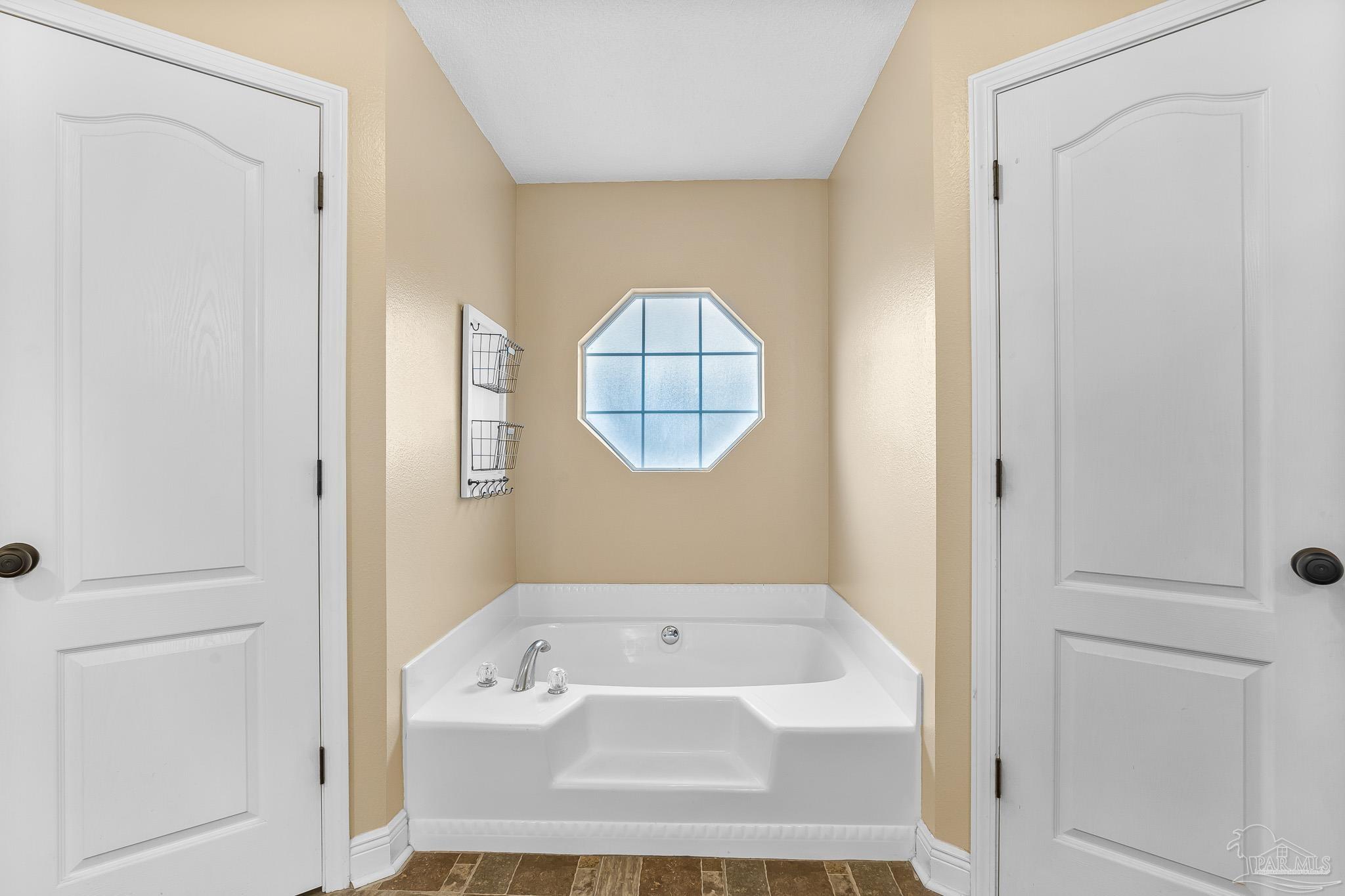 1089 Yellowstone Pass Cantonment, FL 32533 - Photo 23 of 45 a bathroom with a bathtub and a window