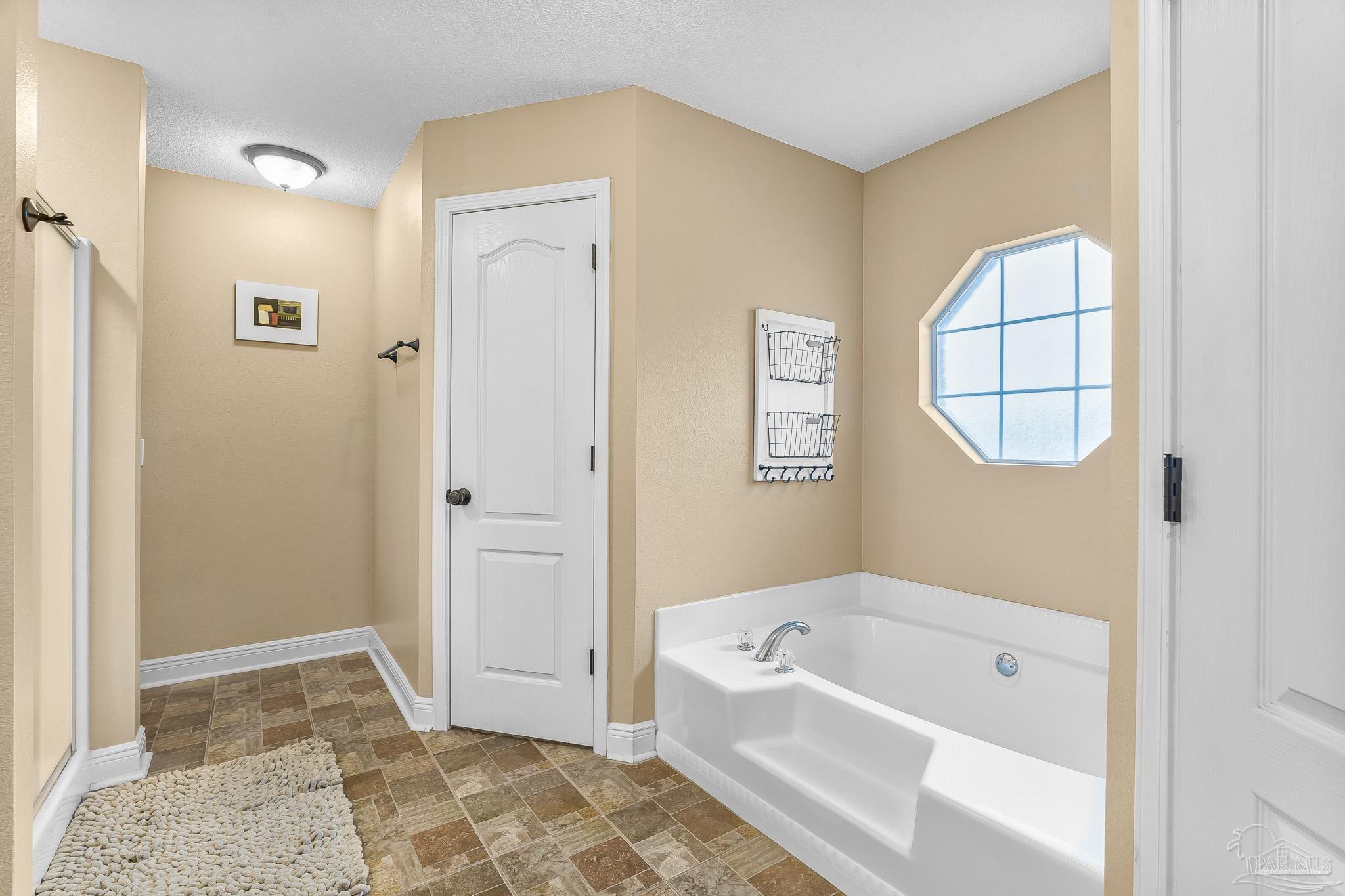 1089 Yellowstone Pass Cantonment, FL 32533 - Photo 25 of 45 a bathroom with a tub shower and a sink