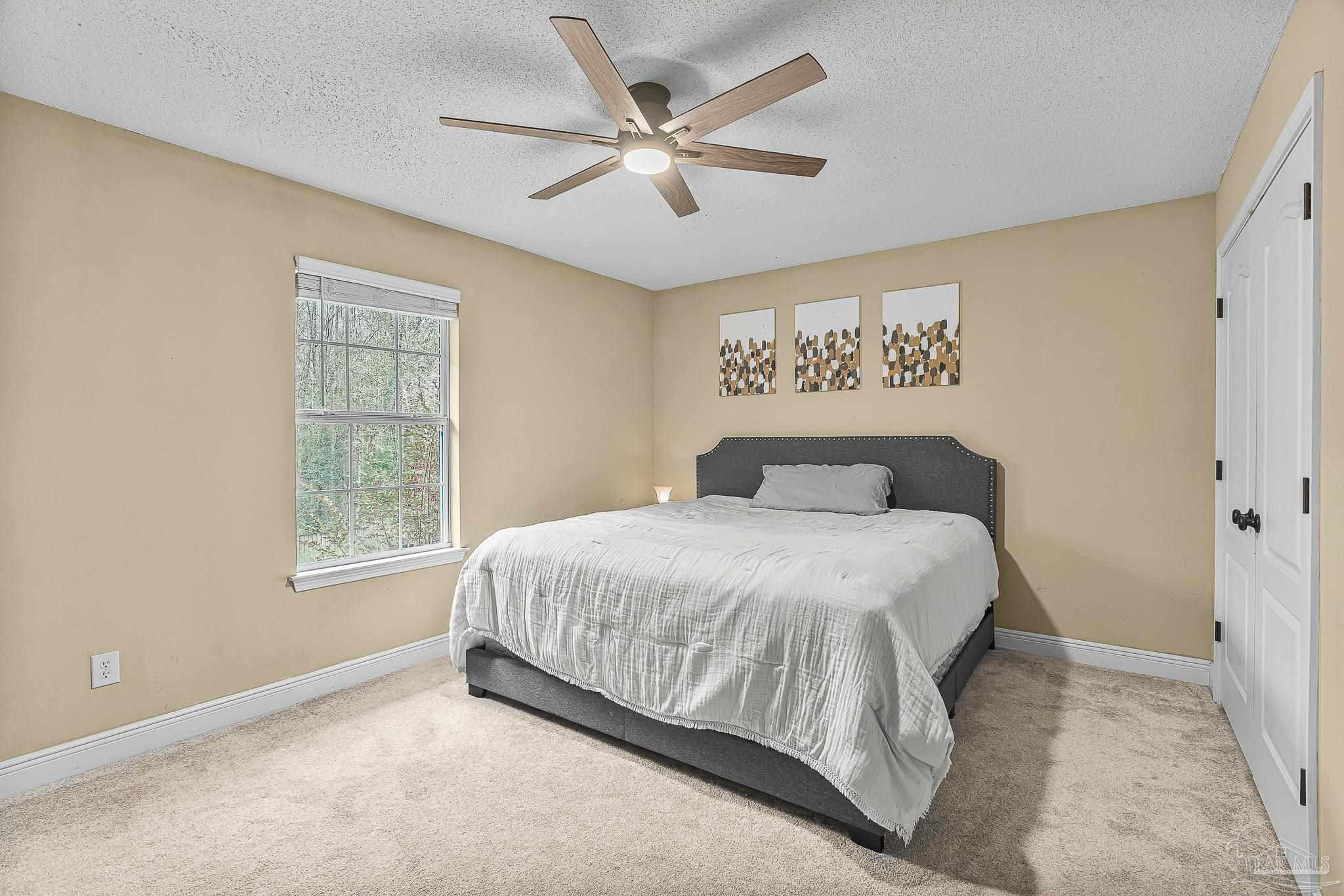1089 Yellowstone Pass Cantonment, FL 32533 - Photo 27 of 45 a bedroom with a large bed and a window