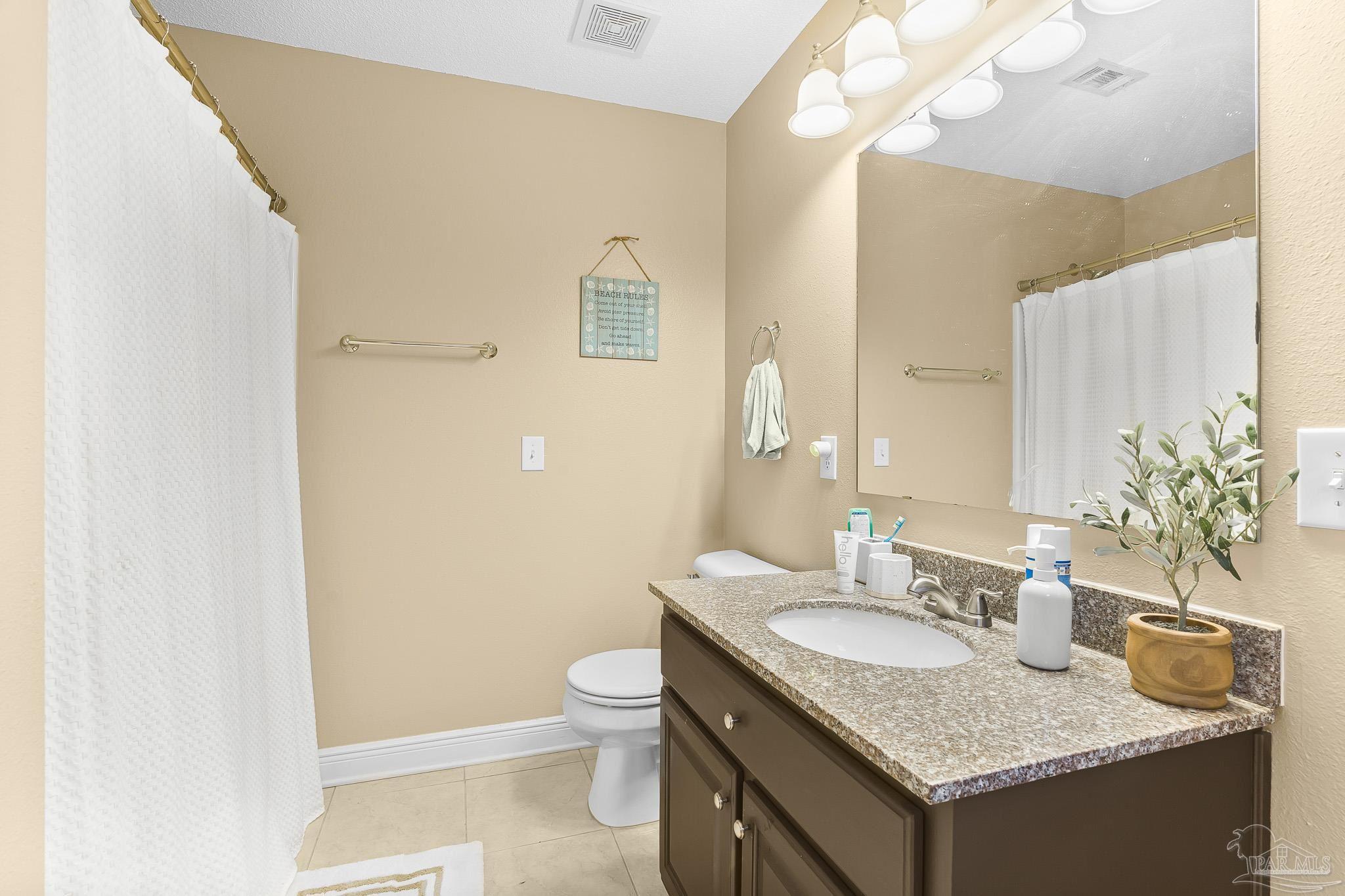 1089 Yellowstone Pass Cantonment, FL 32533 - Photo 29 of 45 a bathroom with a granite countertop sink and a mirror