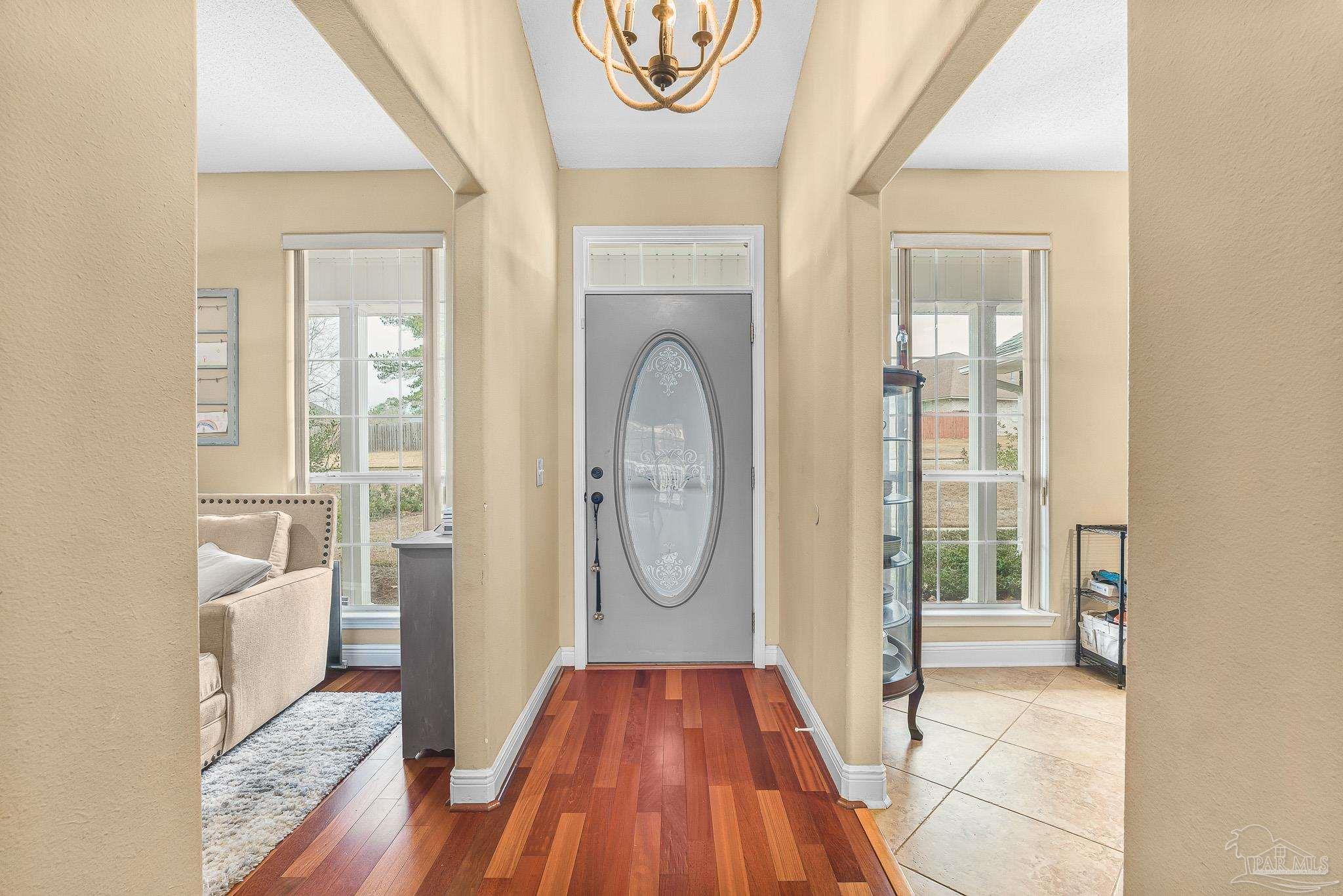 1089 Yellowstone Pass Cantonment, FL 32533 - Photo 3 of 45 a view of a hallway with wooden floor and a livingroom