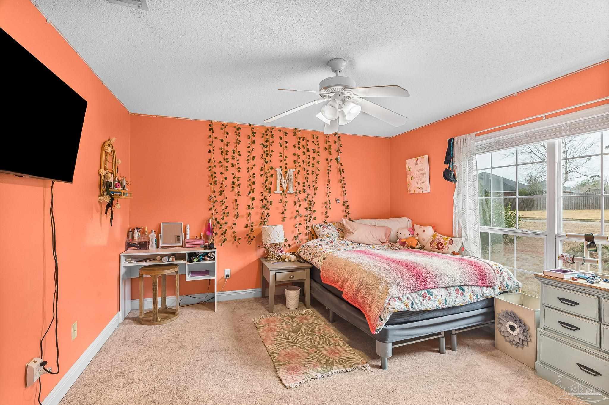 1089 Yellowstone Pass Cantonment, FL 32533 - Photo 31 of 45 a bedroom with a bed and a flat tv screen on dresser