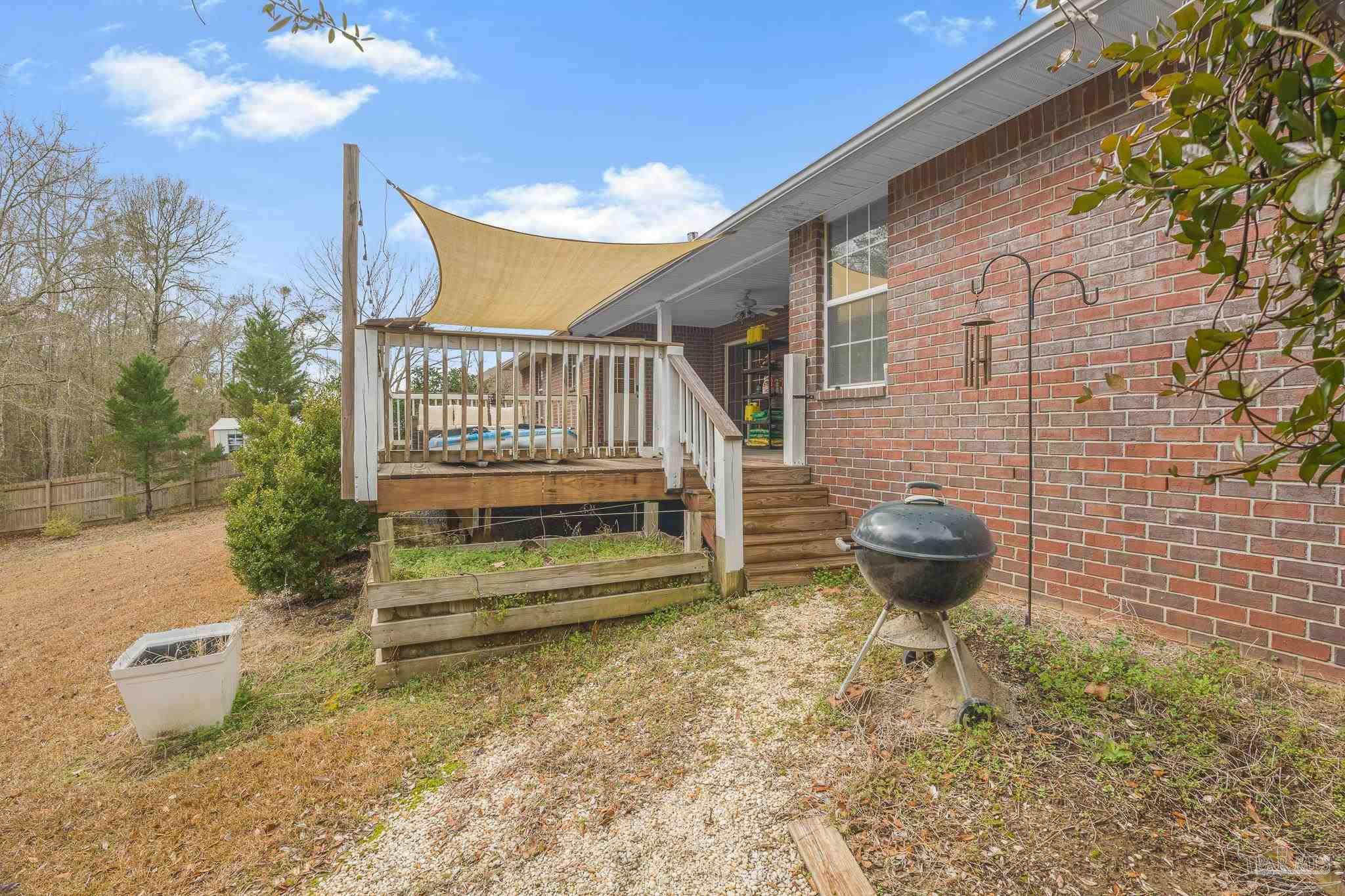 1089 Yellowstone Pass Cantonment, FL 32533 - Photo 40 of 45 a backyard of a house with table and chairs