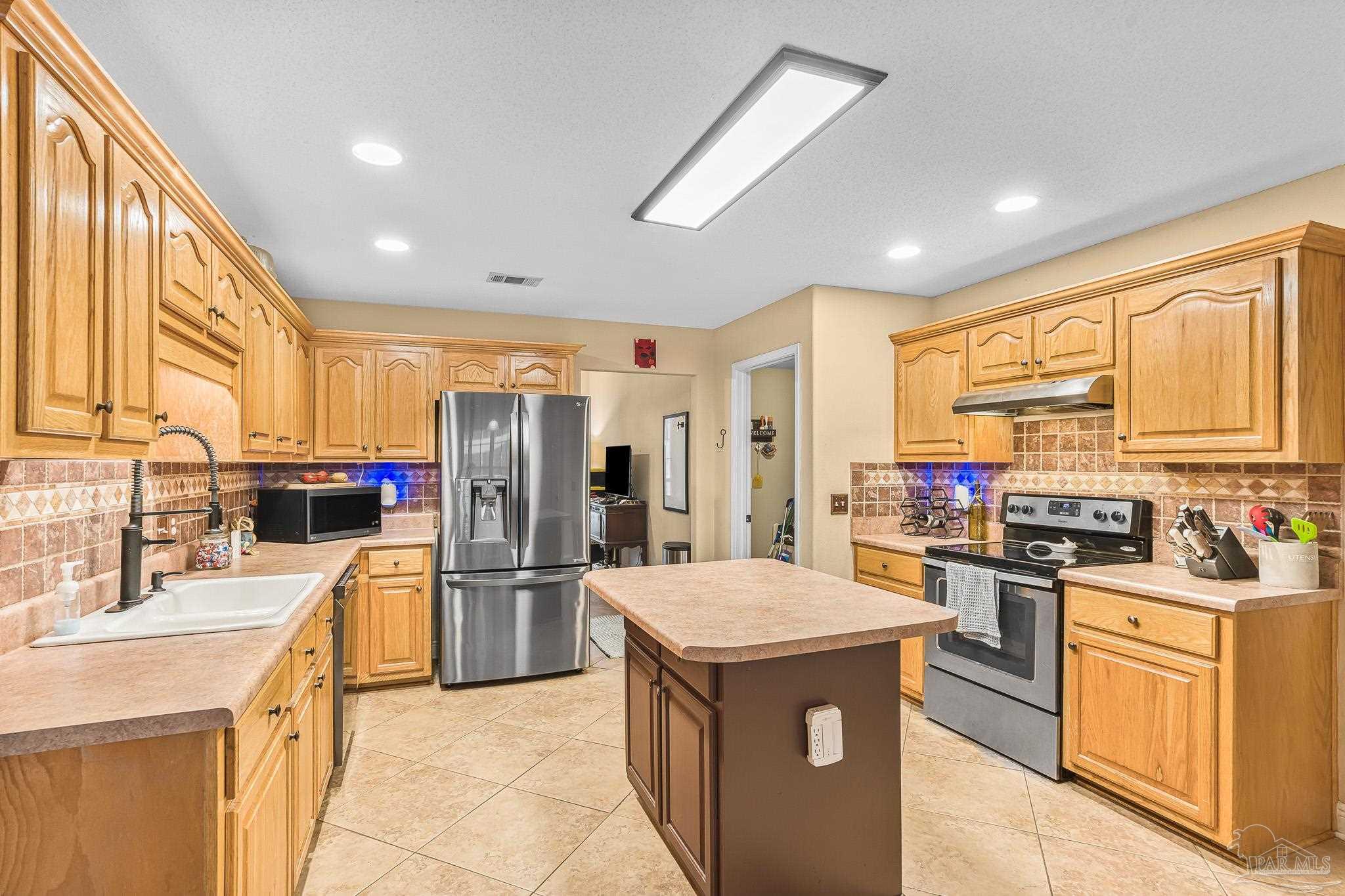 1089 Yellowstone Pass Cantonment, FL 32533 - Photo 4 of 45 a kitchen with stainless steel appliances granite countertop a sink stove and refrigerator