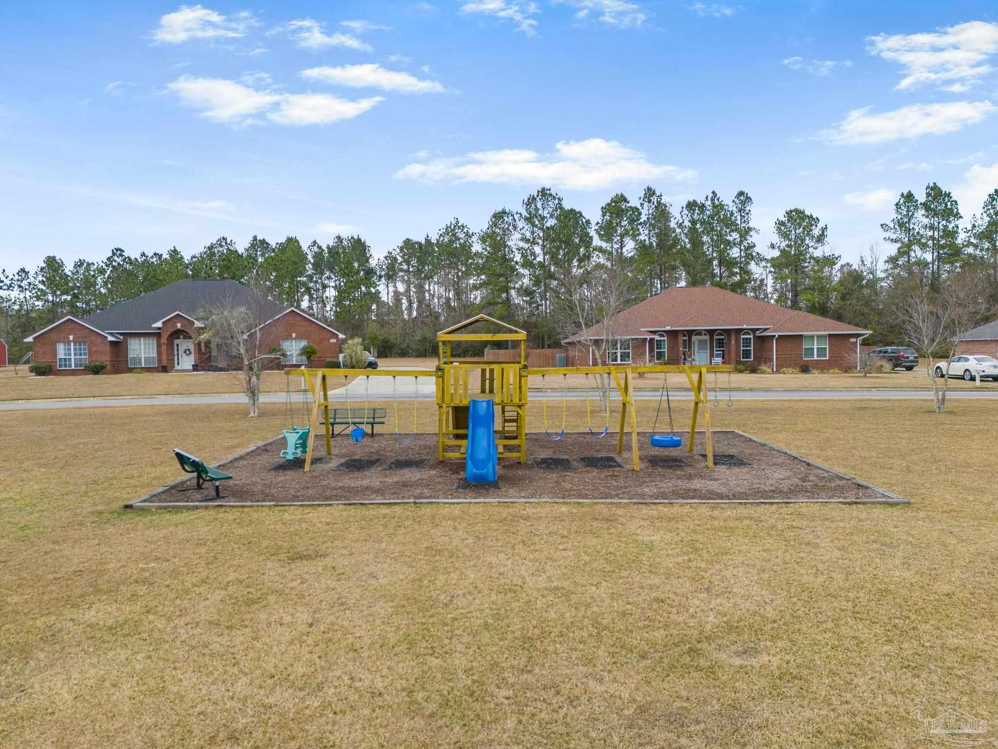1089 Yellowstone Pass Cantonment, FL 32533 - Photo 45 of 45 a view of a swimming pool with lawn chairs under an umbrella