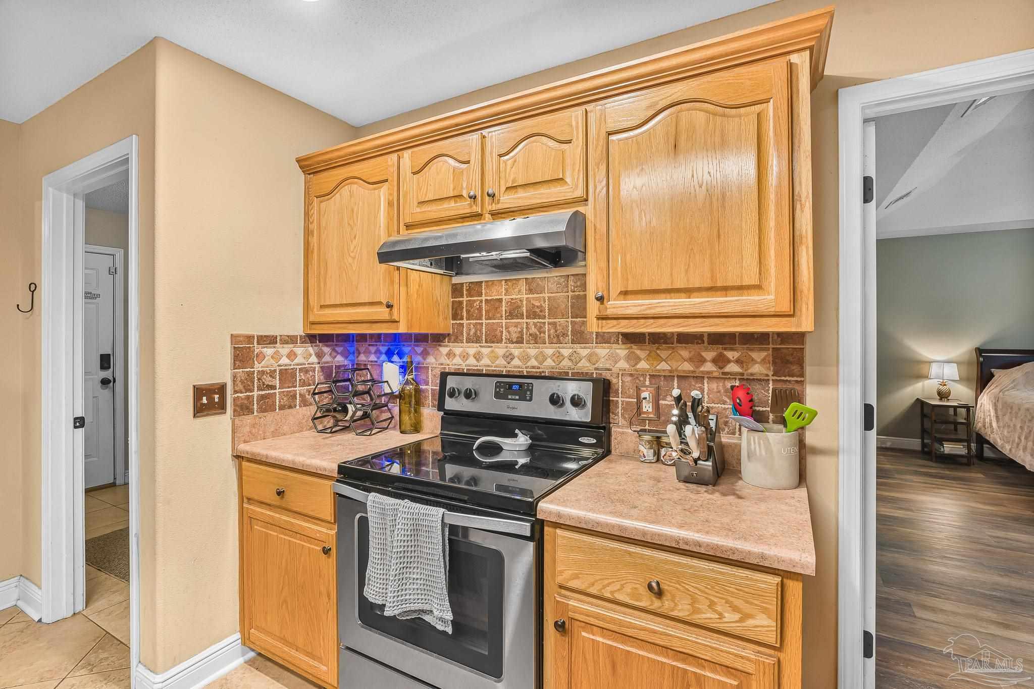 1089 Yellowstone Pass Cantonment, FL 32533 - Photo 6 of 45 a kitchen with stainless steel appliances granite countertop a stove and a refrigerator