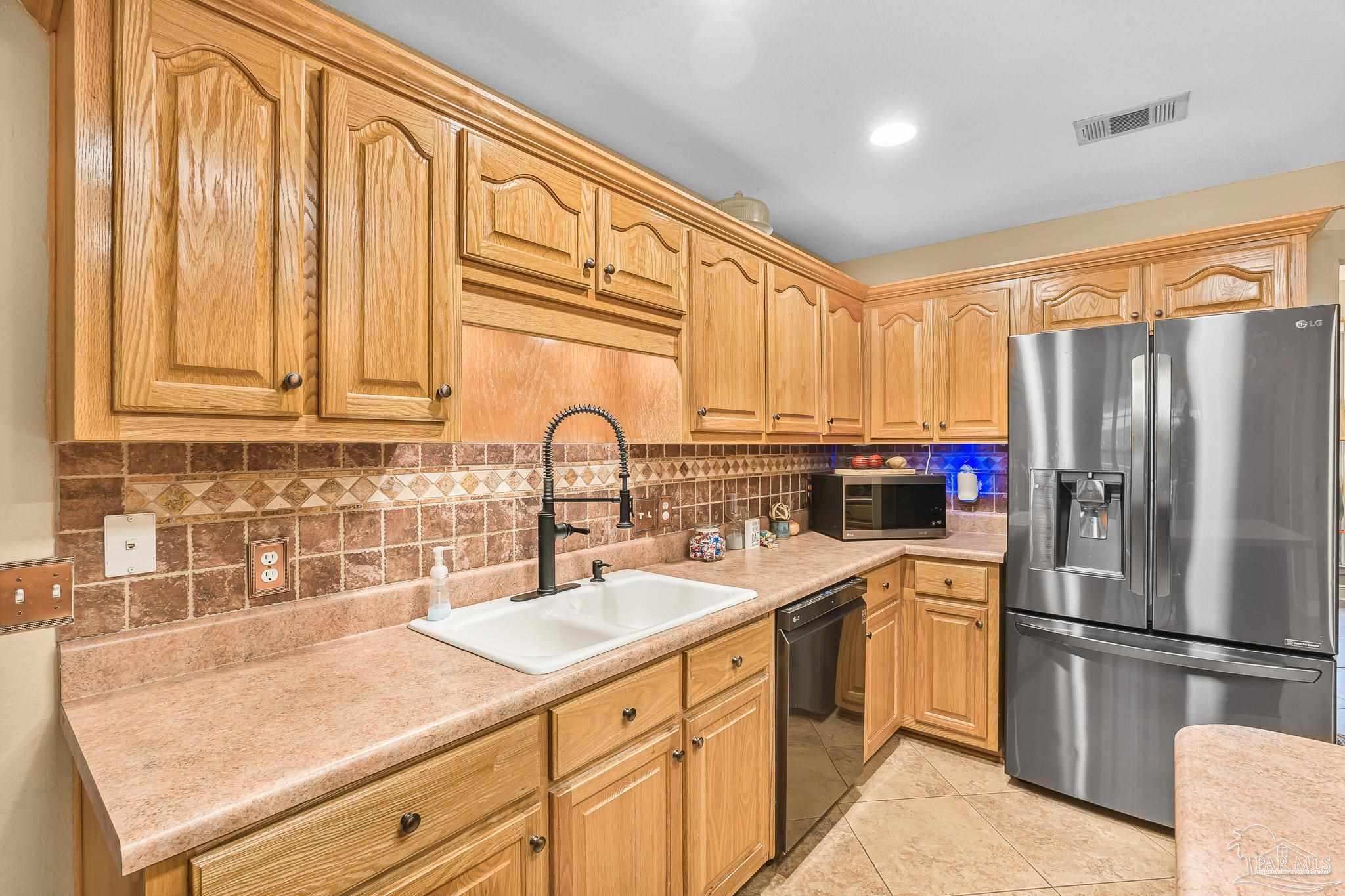 1089 Yellowstone Pass Cantonment, FL 32533 - Photo 7 of 45 a kitchen with a sink cabinets and stainless steel appliances