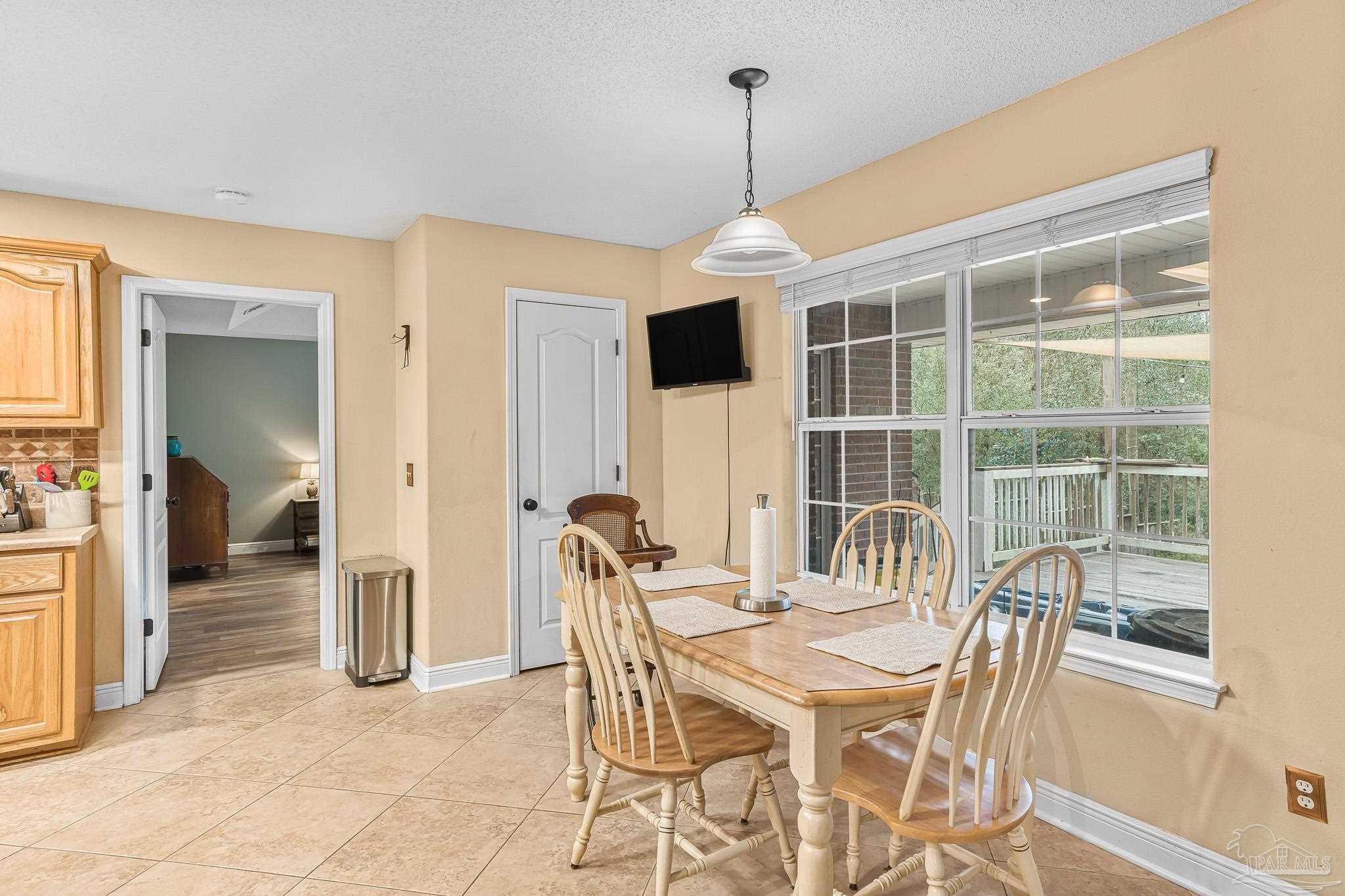 1089 Yellowstone Pass Cantonment, FL 32533 - Photo 9 of 45 a view of a dining room with furniture window and wooden floor