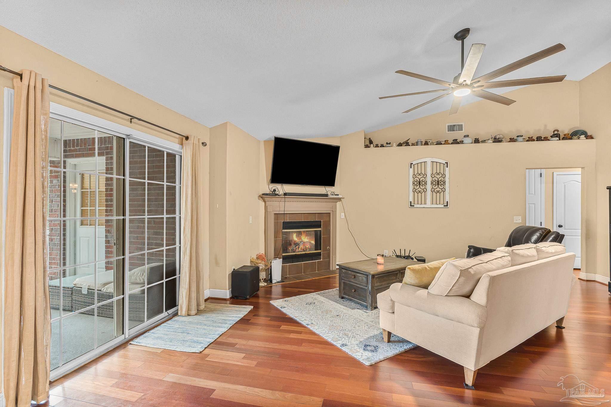 1089 Yellowstone Pass Cantonment, FL 32533 - Photo 10 of 45 a living room with furniture a fireplace and a flat screen tv