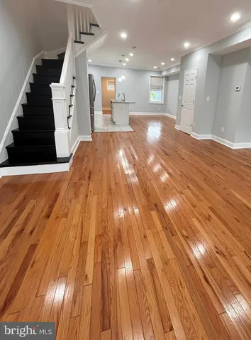 a view of kitchen and hall with wooden floor