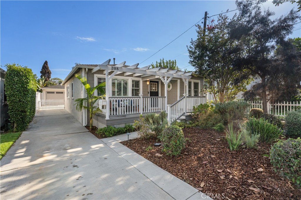 208 West Walnut Avenue El Segundo, CA 90245 - Photo 1 of 38 a front view of a house with a garden
